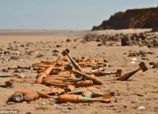 bombs found on UK beach, New danger from the floods is revealed after storms unearth wartime BOMBS on beaches, sinkhole created by Britain's extreme weather video, bomb extreme weather britain, bomb unearthed by extreme weather in Britain, WWII bombs revealed by UK storm 2014, unexplosed bombs revealed by UK storms 2014, sinkhole on Paignton Beach after UK storm 2014, uk storm 2014 reveal hidden hazards, hidden hazards revealed by UK storms February 2014, UK storms 2014: bombs and anti-tank defences discovered, and bombs found on UK beach, 'Sinkhole' appears on Paignton Beach, Ammunition has been unearthed by the terrible weather that battered Britain's coasts, Second World War anti-tank defences emerge from below the sand of storm-lashed beach,