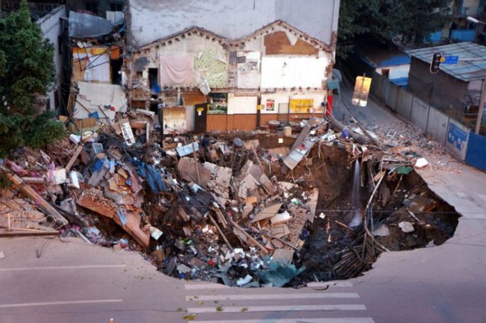 Sinkhole Guangzhou China 2013, most impressive sinkhole around the world photo, photo of impressive sinkhole, sinkhole, sinkhole photo, amazing sinkhole, sinkhole uk 2014, sinkhole photo, photo of sinkholes, largest sinkholes around the world, photo of sinkhole around the world, sinkhole photography, sinkhole picture, sinkhole compilation, sinkhole, Rescuers look for survivors after a building collapsed into a large hole in Guangzhou, China, in January 2013. The demolition was caused by the construction of a metro line and left a nine-metre deep hole in the ground. Picture: China Foto Press/Barcroft Media