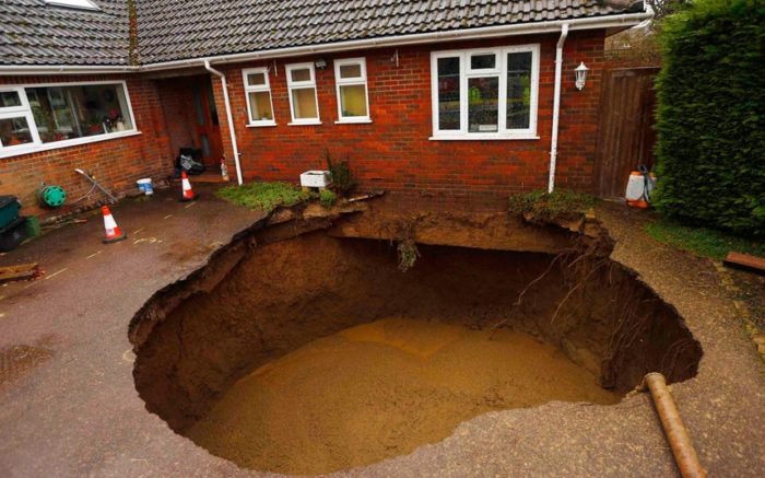 sinkhole, sinkhole photo, amazing sinkhole, sinkhole uk 2014, sinkhole photo, photo of sinkholes, largest sinkholes around the world, photo of sinkhole around the world, sinkhole photography, sinkhole picture, sinkhole compilation, sinkhole, sinkhole in the driveway of a house in Walter's Ash, Buckinghamshire. Picture: Reuters