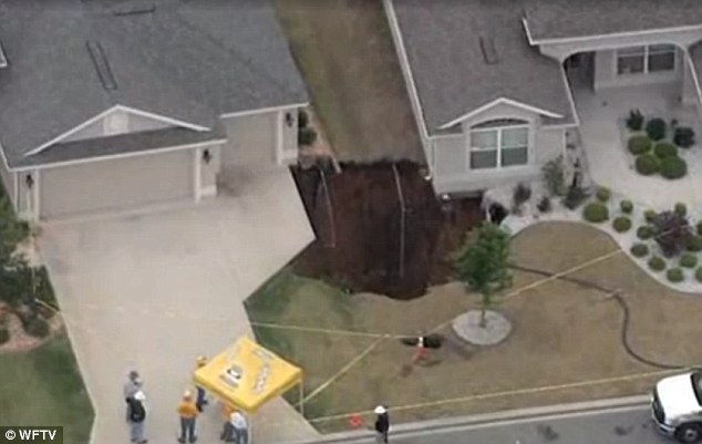huge sinkhole almost swallows two homes in florida april 20 2014, Sinkhole stabilized in Villages neighborhood, sinkhole almost swallows two homes in Villages neighbourhood, Massive sinkhole threatens homes in Sumter County, Massive 50-foot sinkhole springs up in Florida threatens to engulf two homes, Two vacant homes threatened by a huge sinkhole in Florida on April 20, 2014, sinkhole almost swallow two homes in Florida - April 20 2014, huge sinkhole swallows homes in florida april 20 2014, us sinkhole florida april 20 2014, florida sinkhole april 201 2014, monster sinkhole florida april 2014, Two vacant homes threatened by a huge sinkhole in Villages neibouthood in Sumter County in Florida on April 20, 2014