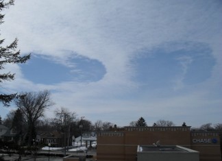 Rare double hole punch cloud (Fallstreak Holes) over Chicago, Rare double hole punch cloud (Fallstreak Holes) over Chicago,Aliens are watching us: These double hole punch clouds in the sky over Chicago on May 9 2014 look like alien eyes watching down to earth.