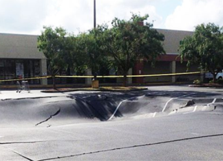 sinkhole, sinkhole florida, sinkhole florida news may 2014, sinkhole florida may 2014 news, sinkhole winter haven florida parking lot news, sinkhole winter haven florida video, video of massive parking lot sinkhole may 2014, sinkhole swallows parking lot in winter haven florida may 29 2014 video, Sinkhole in Winter Haven parking lot - May 29 2014, massive sinkhole swallows parking lot in Winter Haven florida may 29 2014, parking lot swallowed by sinkhole in Winter Haven florida may 2014, massive sinkhole winter haven florida may 2014, sinkhole, cave-in, sinkhole news, sinkhole winter haven may 2014, This monster sinkhole opened up in Winter Haven, Florida on May 29, 2014... It's growth has now slowed down. Photo: WFLA