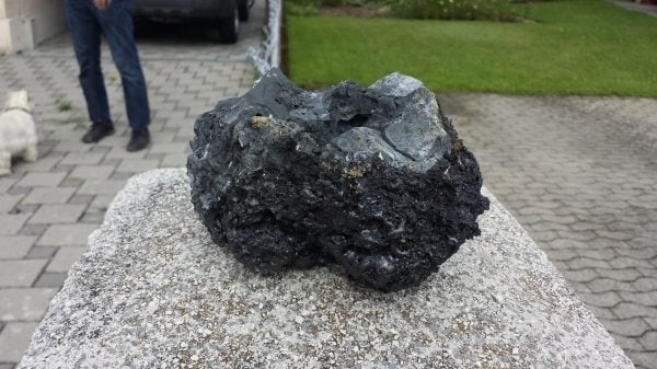 This 20-inches diameter stone landed This chunk landed on the forecourt of a house. Stones were still warm even hours after the explosion. Photo: Pesse, This is not a meteorite! A chunk discovered in the Emme after a steel plant explosion in Switzerland on July 12 2014. Photo: Marcel Pesse, flying glowing rock after steel plant explosion Switzerland, flying rocks steel plant explosion july 2014, meteorite like rocks after explosion steel plant july 2014, steel plant explosion july 2014, swiss steel plant explosion july 2014, loud booms switzerland july 2014, flying glowing rocks after explosion july 2014, explosion, loud booms, blast, switzerland july 2014, flsteel plant explosion, explosion, steel plant explosion, Switzerland, mystery boom, mystery boom and rumbling, loud booms during steel plant explosion in Switzerland july 2014, huge meteorite-like chunks of rock created by steel plant explosion in Switzerland july 2014, steel plant explosion triggers giant flying rock in Switzerland, giant flying orbs fly over Switzerland after steel plant explosion, meteorite like rocks fly over swiss city after steel plant explosion