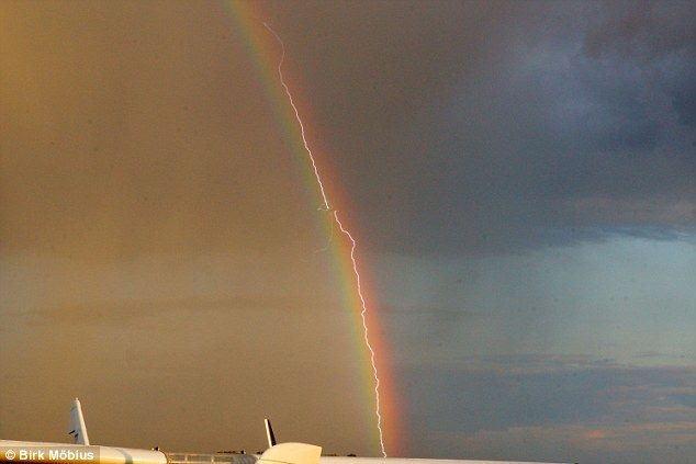 lightning airplaine rainbow photo, lightning hits plane in front of rainbow photo, nature phenomena photo, best nature photo, best plane photo, lightning rainbow plane photo, This is one of the best nature shot ever: Lightning strikes plane in front of a rainbow!, Perfect Timing! Amazing photo shows a lightning striking a plane in front of a rainbow! WOW!, The airplane flying from Frankfurt to Leipzig was struck by a lightning in front of a rainbow just before landing, nature photo, perfect photo, lightning photo, rainbow photo, amazing photo, germany