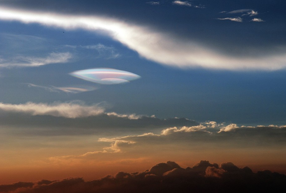 This mysterious giant multicolor ufo-shaped lenticular cloud was spotted in the sky over China on August 4 2014 just hours after the deadly quake of AUgust 3 2014., But what is this mysterious giant muticolor ufo-like cloud in the sky asked the boy... It's a lenticular fire rainbow answered the father!, strange cloud, iridescent cloud, lenticular clouds, giant mysterious cloud, China, earthquake sign, photo
