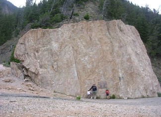 Photo of a giant rock boulder carried by the slide triggered by the 1959 Hebgen Lake earthquake. Photo: Wikicommon, Damages created by the 1959 Hebgen Lake earthquake also known as the 1959 Yellowstone earthquake. Photo: Wikicommon, View of the Hebgen Lake Landslide which blocked the Madison River Canyon after the 1959 Yellowstone Earthquake. Phto: Wikicommon, EARTHQUAKE LAKE, Quake Lake, The 1959 Hebgen Lake earthquake, 1959 Yellowstone earthquake, quake lake history, earthquake lake history, earthquake lake formation 1959, earthquake lake formed after 1959 yellowstone earthquake