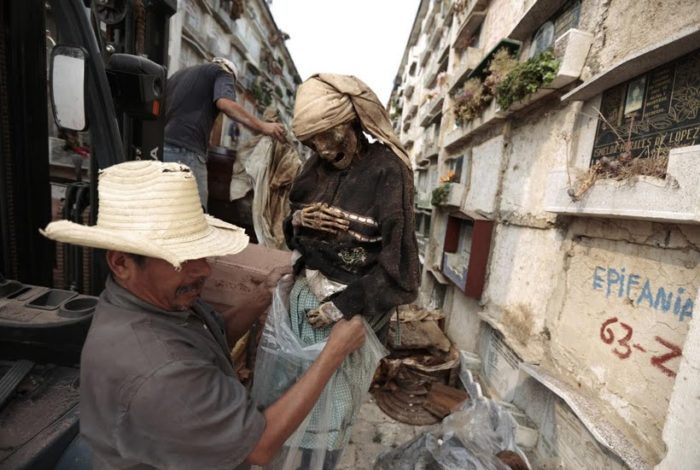 The Destitute Cemetery City of Guatemala, A grave cleaner removes a mummified body from a crypt at La Verbena Cemetery in Guatemala City., grave cleaner La Verbena Cemetery, La Verbena Cemetery Guatemala city, La Verbena Cemetery Guatemala, terrifying La Verbena Cemetery, La Verbena Cemetery photo, creepy La Verbena Cemetery
