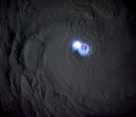 lightning Tropical Cyclone Bansi photo, lightning bansi picts, iss photo lightning bansi, lightning lighting up the eye of Tropical Cyclone Bansi in the Indian Ocean, look into the eye of the cyclone, cyclone bansi pictures, best aerial photo bansi cyclone, best pictures of cyclone bansi