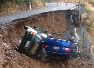 sinkhole Dunedin NZ june 2015, sinkhole Dunedin NZ june 2015, two cars swallowed by sinkhole in dunedin, dunedin sinkhole swallows two cars june 2015, deluge creates sinkhole in dunedin nz june 2015, 2 cars swallowed by sinkhole dunedin june 2015, The two cars swallowed by the giant sinkhole in Dunedin, New Zealand on June 3 2015., A close-up picture of the two cars at the bottom of the sinkhole. Photo: Mark Walton