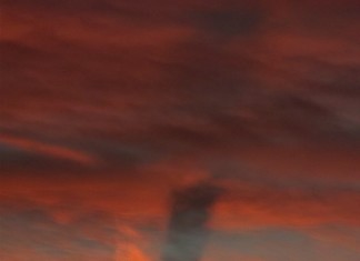 contrail shadow, contrail shadow at sunset, contrail shadow at sunset picture, picture of contrain shadow at sunset, colarado contrail shadow, contrail shadow colorado october 31 2015 photo, The shadow of a twisting contrail appears under some clouds in the sky of Colorado