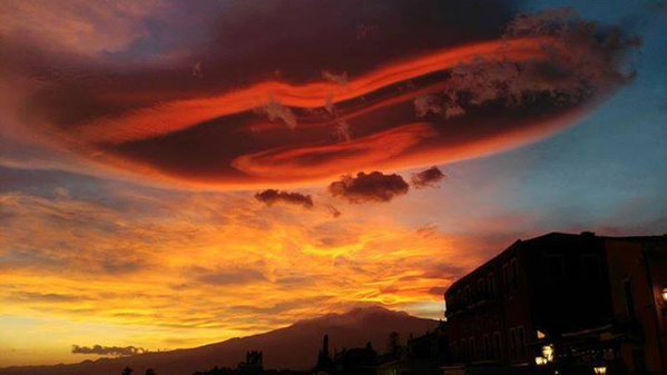 lenticular clouds italy, lenticular clouds lotejanni italy, lenticular clouds etna italy, sky on fire, lenticular cloud picture, This fiery lenticular cloud formed in the sunset sky of Italy on November 21 2015, As if the lenticular cloud was about to swallow up Mount Etna.