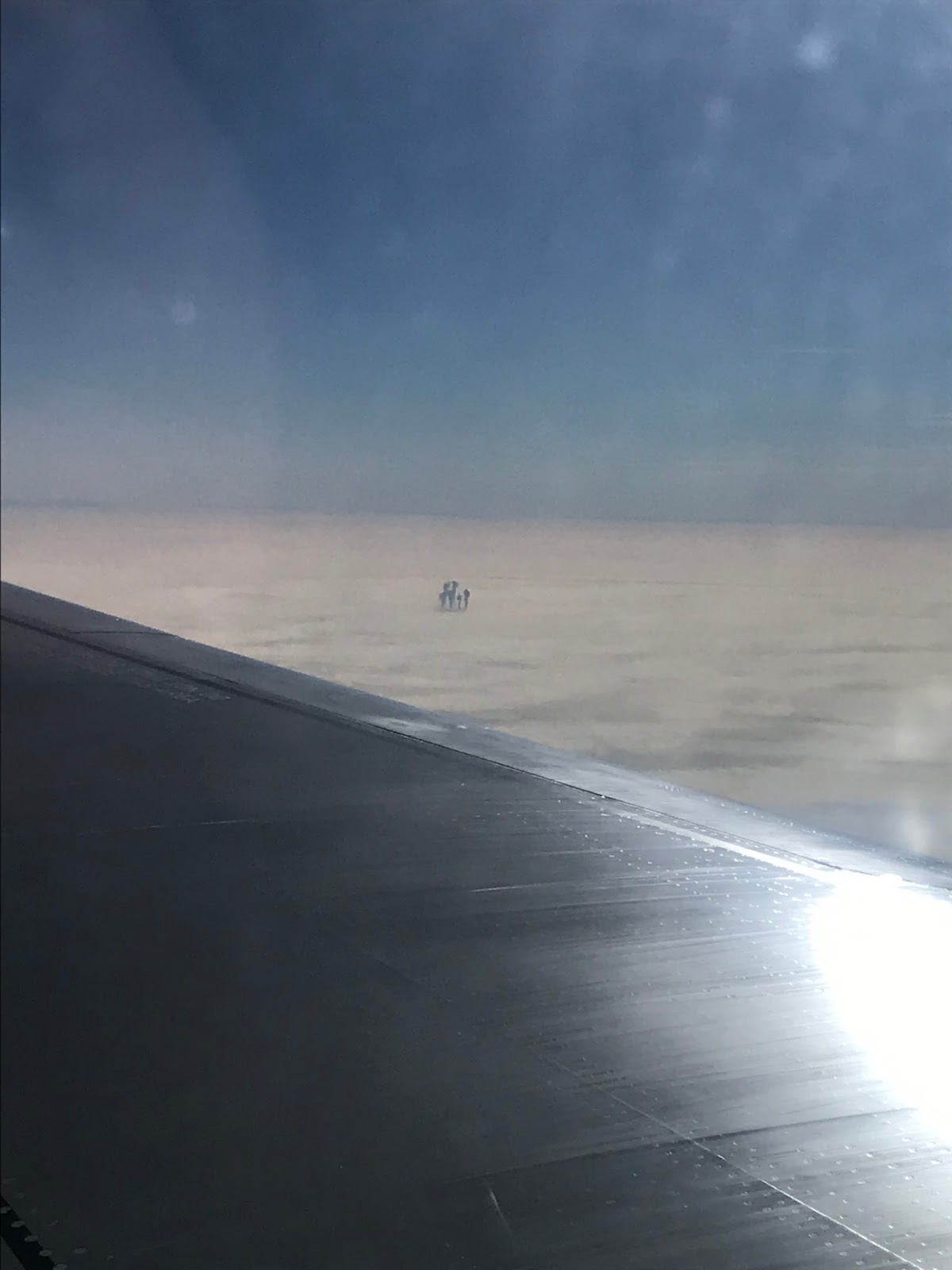 This strange humanoid clouds were observed during a flight Warsaw-London, humanoid cloud, strange cloud warsaw london, strange cloud poland