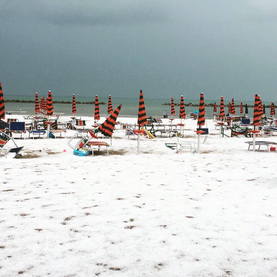 The beach turned white after a freak hailstorm hit Grottammare Italy on July 25 2017 afternoon, beach turns white after hailstorm in italy grottammare, italian beach turns white after hailstorm, hailstorm italy beach white