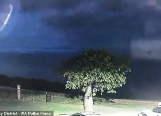 'We may not be alone': Police release eerie footage of a UFO-like object hovering in the sky during an intense thunderstorm in Australia's remote northwest