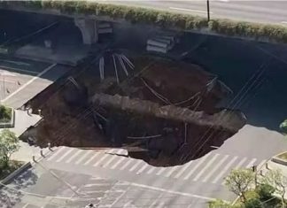 Three people missing after giant 100ft sinkhole swallows up lorry and scooter in Guangzhou China, Three people missing after giant 100ft sinkhole swallows up lorry and scooter in Guangzhou China video, Three people missing after giant 100ft sinkhole swallows up lorry and scooter in Guangzhou China pictures, Three people missing after giant 100ft sinkhole swallows up lorry and scooter in Guangzhou China december 2019