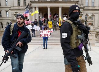 coronavirus protests usa, Protesters carry rifles near the steps of the Michigan State Capitol as they voiced opposition to the state's lockdown coronavirus protests usa video, coronavirus protests usa pictures,