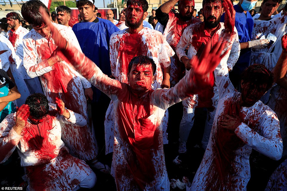 Devout Shiite Muslims are left covered in blood as they flagellate themselves with swords and chains during mourning procession to mark day of Ashura in Iraqi holy city of Najaf