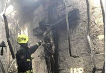 Wooden crucifix reminds intact after fire destroys church