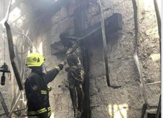 Wooden crucifix reminds intact after fire destroys church