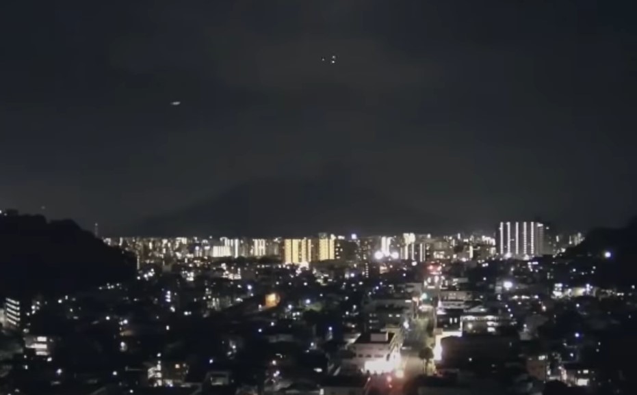 A giant ufo chased by a group of orbs over Sakurajima volcano in Japan