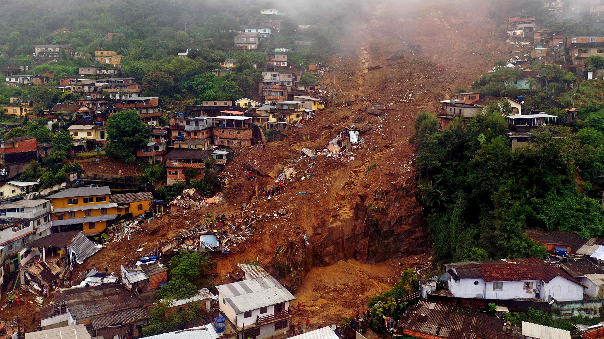 Apocalyptic floods and huge mudslides kill at least 120 people after 10