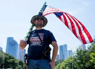 Texas Republicans are pushing for a referendum to see if the state should secede from the U.S. Above, Kenny Wolfam open carries a pistol and wears a "Trump 2020" t-shirt while counter-protesting a "Moms Demand Action" protest at Buffalo Bayou Park in Houston, Texas on June 17, 2021. MARK FELIX