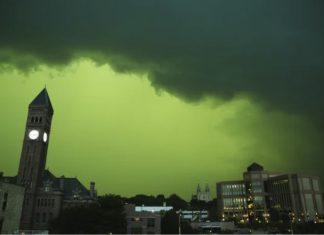 The sky turns green during a severe storm in downtown Sioux Falls, South Dakota, on July 5, 2022. Twitter/jkarmill