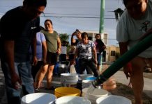 Residents wait in line for not potable water delivered by a tanker truck in Colonia Mirador de Garcia on Tuesday, July 19, 2022 in Garcia, NUEVO LEON.