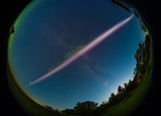 A fish-eye-lens photo of STEVE, the mysterious purple river of light, hanging in the sky over Canada. Picture Alan Dyer-AmazingSky.com