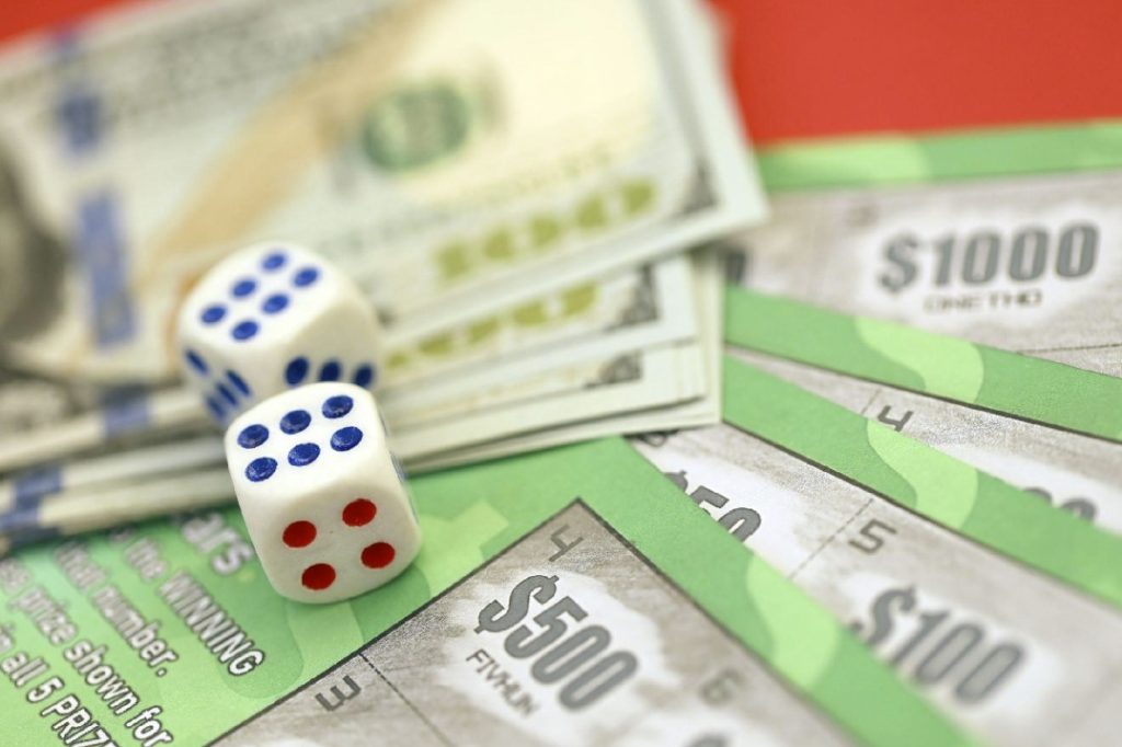 Close up view of green lottery scratch cards with us dollar bills and dice. Many used fake instant lottery tickets with gaming results 12302584 Stock Photo at Vecteezy