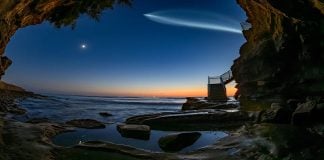 SpaceX Falcon 9 Turns West Coast Skies Into a “Space Jellyfish” — Photos & Where It Was Visible SpaceX Falcon 9 jellyfish plume glowing above the Pacific Ocean seen from a coastal cave in California.