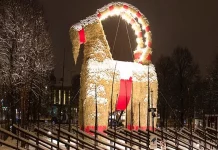 The Goat Still Stands (and Everything Else Is on Fire) The Gävle Goat in Sweden illuminated at night, a giant straw Christmas goat watched worldwide via live webcam