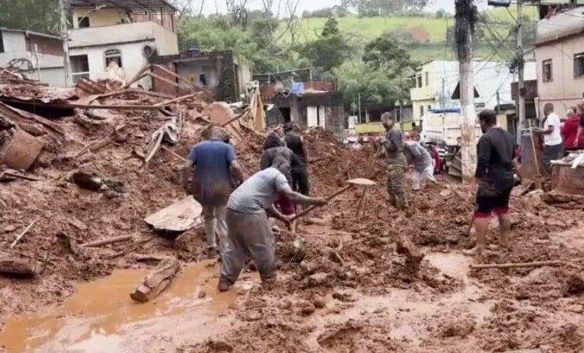 Rescuers digging through mud after a landslide and mudflow in Minas Gerais, Brazil, following extreme rainfall in February 2026