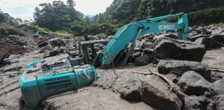 Mount Merapi “Cold Lava” Flood: What a Lahar Is and Why Rain Makes Volcano Slopes Deadly (Mar 2026) Excavator buried in volcanic mud and boulders after a rain-triggered lahar from Mount Merapi in Indonesia